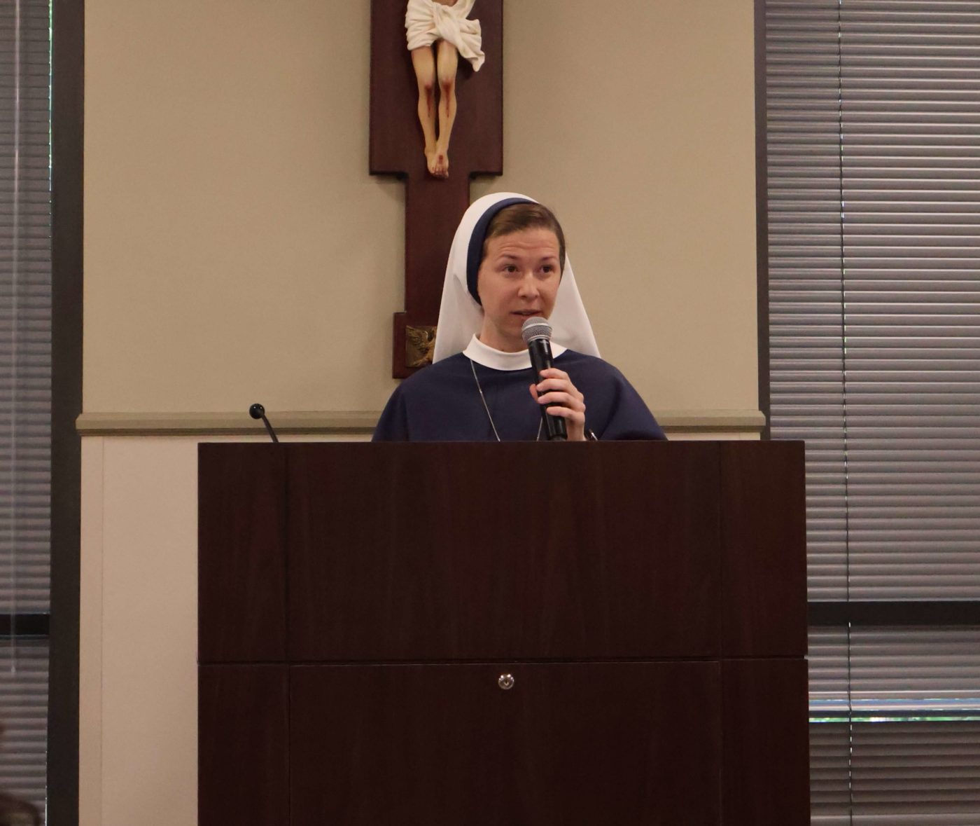 Sister Ann Imaculee speaks at the podium